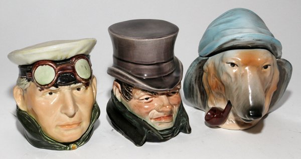 CONTINENTAL PORCELAIN TOBACCO JARS, THREE, H 6": CONTINENTAL PORCELAIN TOBACCO JARS, LATE 19TH-EARLY 20TH C., THREE, H 6":Including 1 figure of a dog smoking a pipe, Made in Slovakia, 1 figure of a driver, and 1 figure of a man wearing a top hat.