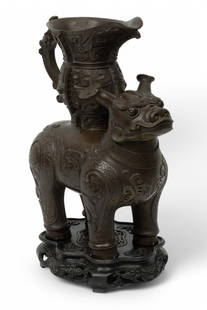 Chinese Bronze Mysterious Beast Sculpture H 13" W 11": Chinese Bronze Mysterious Beast Sculpture H 13" W 11" Highly ornamented body with collar and raised trappings. Beast with horns, bulging eyes, standing erect with urn on back.&nbsp; Dimensions: 1 PC x