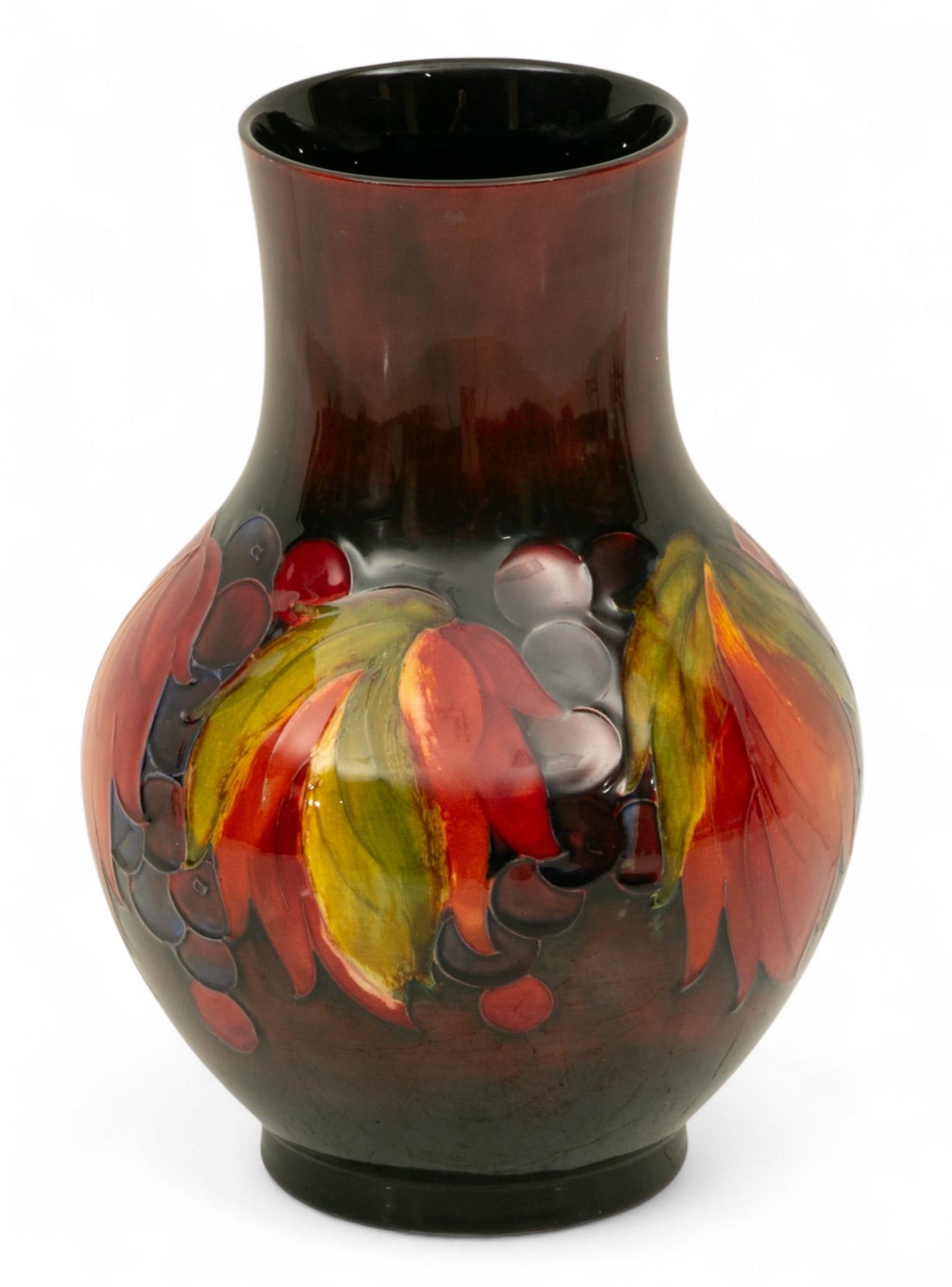 William Moorcroft (English, 1872-1945) Pottery Vase 1950, 'Leaf And Berry Flambe', H 10" Dia. 7" 1: William Moorcroft (English, 1872-1945) Pottery Vase 1950, 'Leaf And Berry Flambe', H 10" Dia. 7" 1 PC Vibrant glaze. Impressed vintage trademerk Dimensions: 1 PC x H 10" Dia 7"