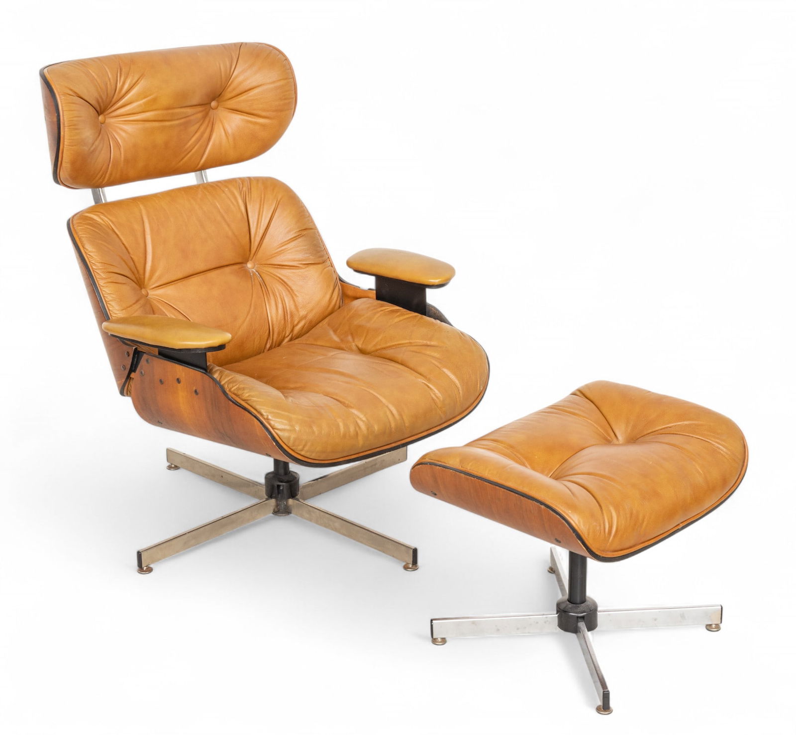 Selig Manufacturing Leather Chair And Ottoman H 38" W 30": Selig Manufacturing Leather Chair And Ottoman H 38" W 30" Brown leather armchair and ottoman in the Eames style. Ottoman having a height of 16", width of 21" and a depth of 17". Provenance: Property