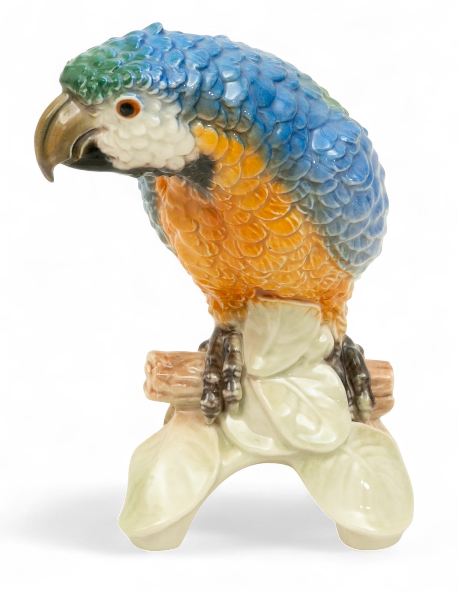 Goebel Porcelain Macaw Parrot H 8.5" W 0.5" Depth 4.5": Goebel Porcelain Macaw Parrot H 8.5" W 0.5" Depth 4.5" Vintage multi color parrot. Blue and green. Standing on branch. Provenance: Property from a Bloomfield Hills, MI private collector. Dimens