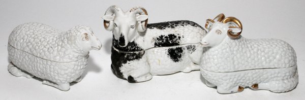 RUSSIAN PORCELAIN RAM BOX & ANOTHER BOX: RUSSIAN PORCELAIN RAM BOX & ANOTHER BOX, L 6 3/4":Including 1 Russian porcelain box in the form of a recumbent ram, painted black and gilt accents, stamped in blue at the underside, H.4 1/2", L.6 3/4"
