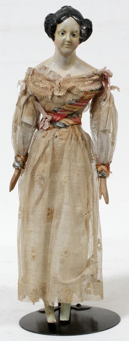 GERMAN PAPIER MACHE MILLINER'S MODEL, C. 1830: GERMAN PAPIER MACHE MILLINER'S MODEL, C. 1830, H 14":Papier mache shoulder head with braided bun and side curls, painted blue eyes, kid body with wooden arms and legs, wearing an antique lace dress wi