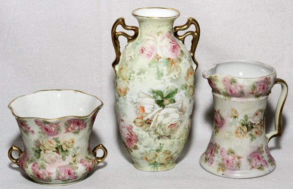 ROYAL BAYREUTH TAPESTRY WARE, H 2 1/2"-5 3/4": ROYAL BAYREUTH TAPESTRY WARE, THREE PIECES, H 2 1/2"-5 3/4":Including 1 sugar bowl and 1 creamer set, and 1 bud vase; all are marked in blue at the underside.