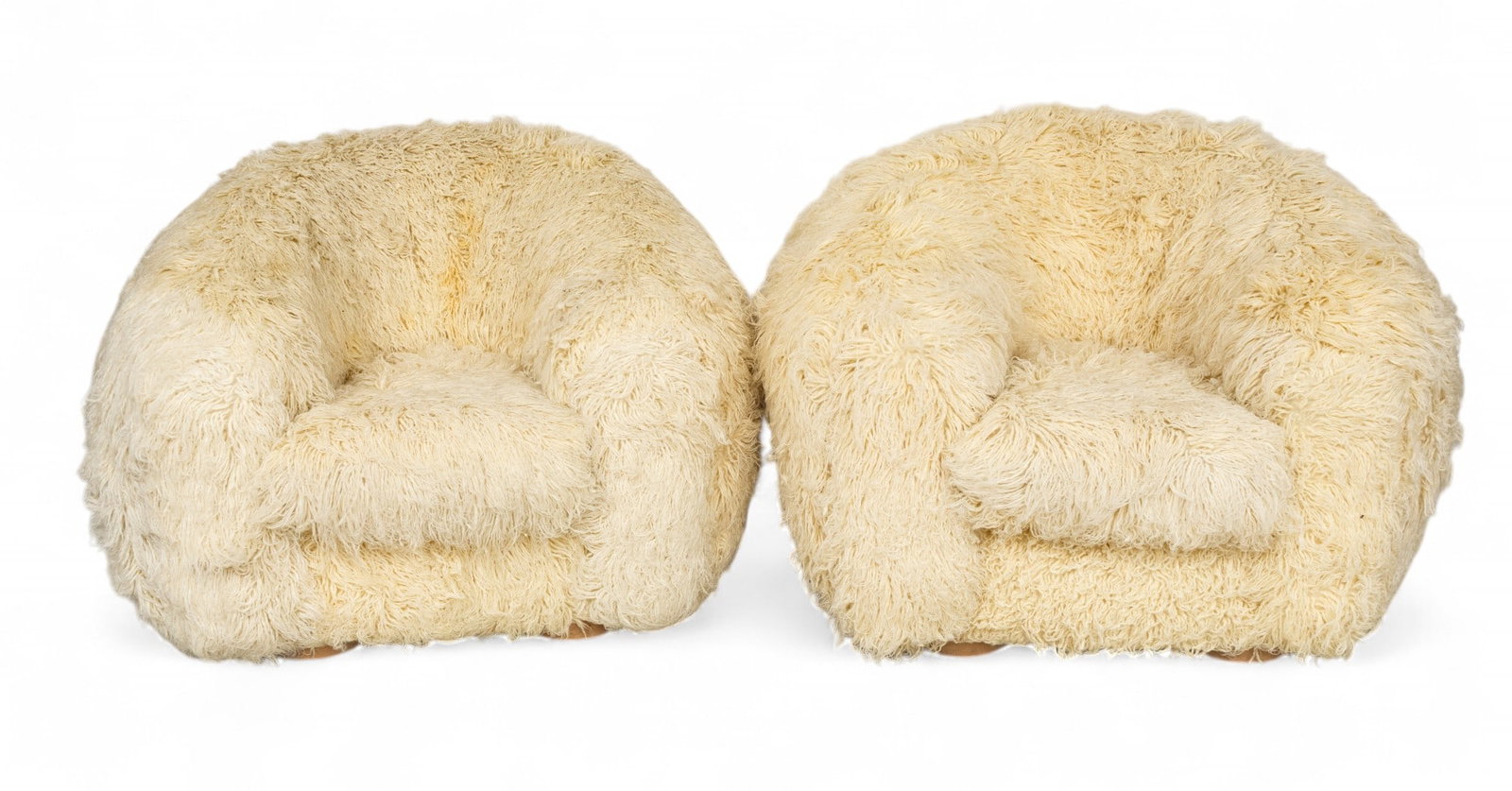 In the Manner of Jean Royère (French, 1902-1981) "Polar Bear" Chairs, Late 20th C., H 32" W 45": In the Manner of Jean Royère (French, 1902-1981) "Polar Bear" Chairs, Late 20th C., H 32" W 45" Depth 45" 1 PAIR Two club chairs upholstered in shaggy wool. Short turned wood legs. No apparent la