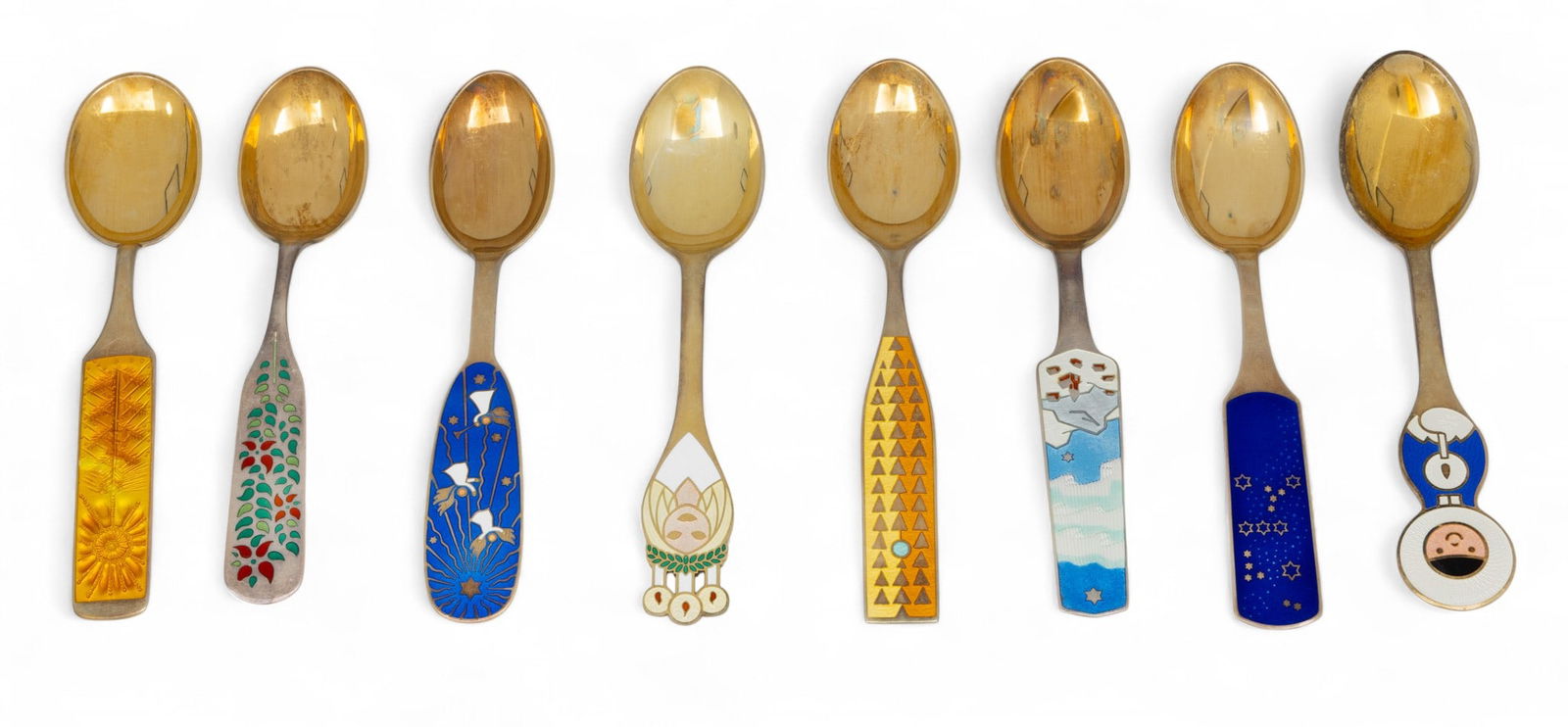 A. Michelsen (Danish) Gilded Sterling Silver Enameled Christmas Spoons L 6.5" 8 PCS: A. Michelsen (Danish) Gilded Sterling Silver Enameled Christmas Spoons L 6.5" 8 PCS Part of a series of collectable Christmas spoons produced annually by Danish company A. Michelsen. This lot features