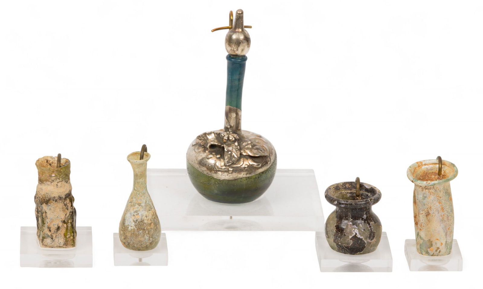 Roman Glass Miniature Cosmetic Container Grouping 4 PCS: Roman Glass Miniature Cosmetic Container Grouping 4 PCS Four pieces ranging from 1.5" to 2". PLUS one modern Domar .925 silver over modern glass bottle with stopper, H 4". Provenance: Property