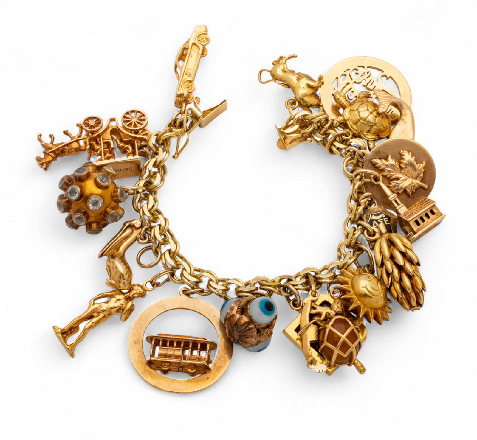 14k Yellow Gold Charm Bracelet L 6" 85 g: 14k Yellow Gold Charm Bracelet L 6" 85 g Stamped 14k and tested 14k gold charm bracelet having nineteen gold charms. Charms include Walt Disney World logo, bunch of bananas, sun, two turtles, trolly,