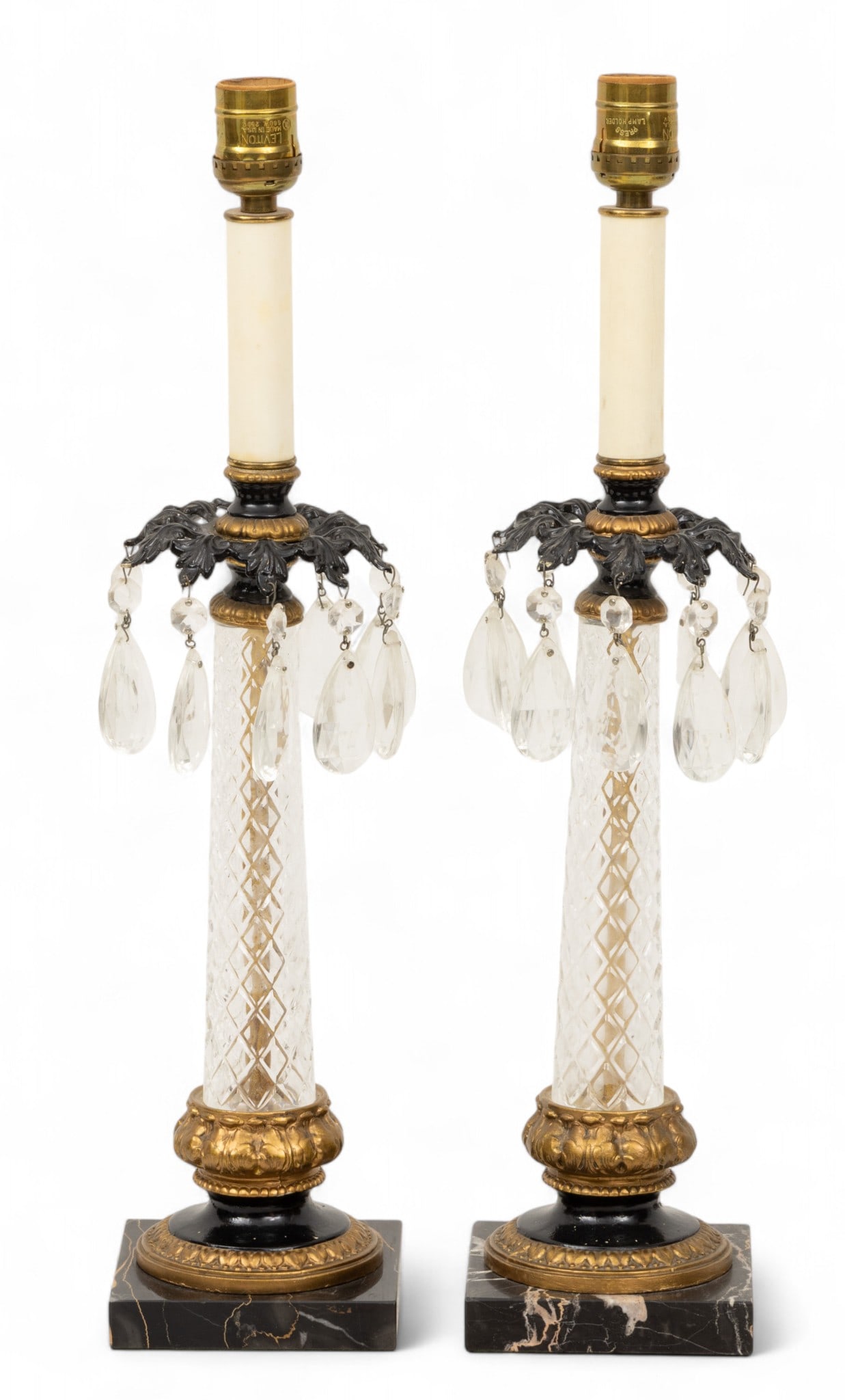 Crystal, Bronze and Marble Candlestick Electric Lamps 1930, H 20" W 4.5" L 4.5" 1 PAIR: Crystal, Bronze and Marble Candlestick Electric Lamps 1930, H 20" W 4.5" L 4.5" 1 PAIR Black square marble bases. Four bronze circular fittings to encase tapered shaft in hand cut crystal diamond patt