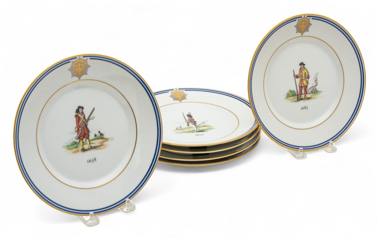 Royal Copenhagen (Danish) Porcelain Plates 1990, 'Military Uniforms from 1658 - 1983', 6 PCS: Royal Copenhagen (Danish) Porcelain Plates 1990, 'Military Uniforms from 1658 - 1983', 6 PCS Cobalt blue bands. Illustrated uniforms at center of each plate. Dimensions: 6 PCS