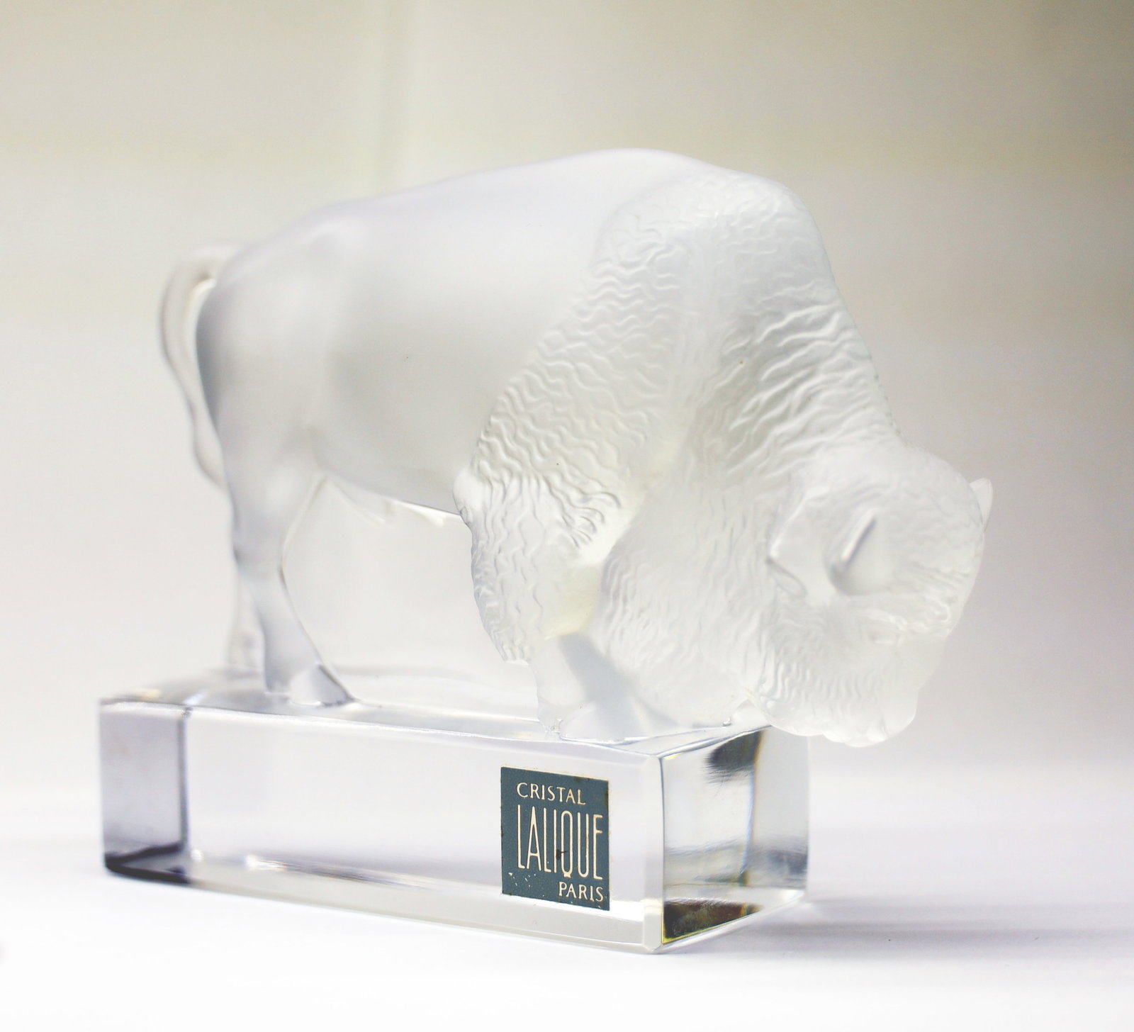 Lalique (French) Buffalo H 4" W 2" L 5.5": Lalique (French) Buffalo H 4" W 2" L 5.5" Lalique label adhered to base. Dimensions: H 4" W 2" L 5.5"
