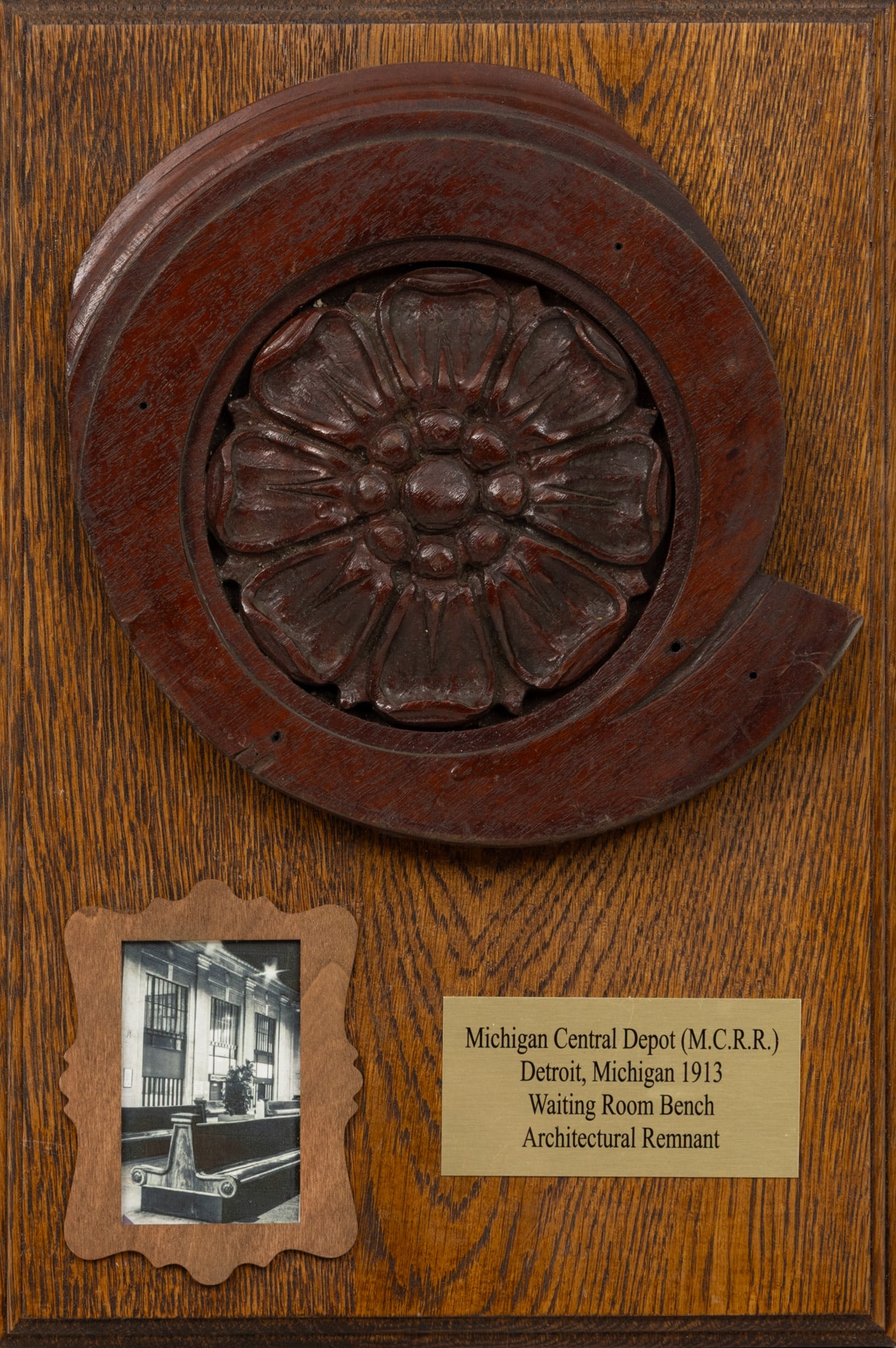 Michigan Central Railroad Depot Carved Wood Ornamental Element, Ca. 1913, Dia. 9" Frame Size: H: Michigan Central Railroad Depot Carved Wood Ornamental Element, Ca. 1913, Dia. 9" Frame Size: H 15.25" W 10.25" Carved wood rosette Dia. 9" mounted to an oval plaque H 15.25" W 10.25". 