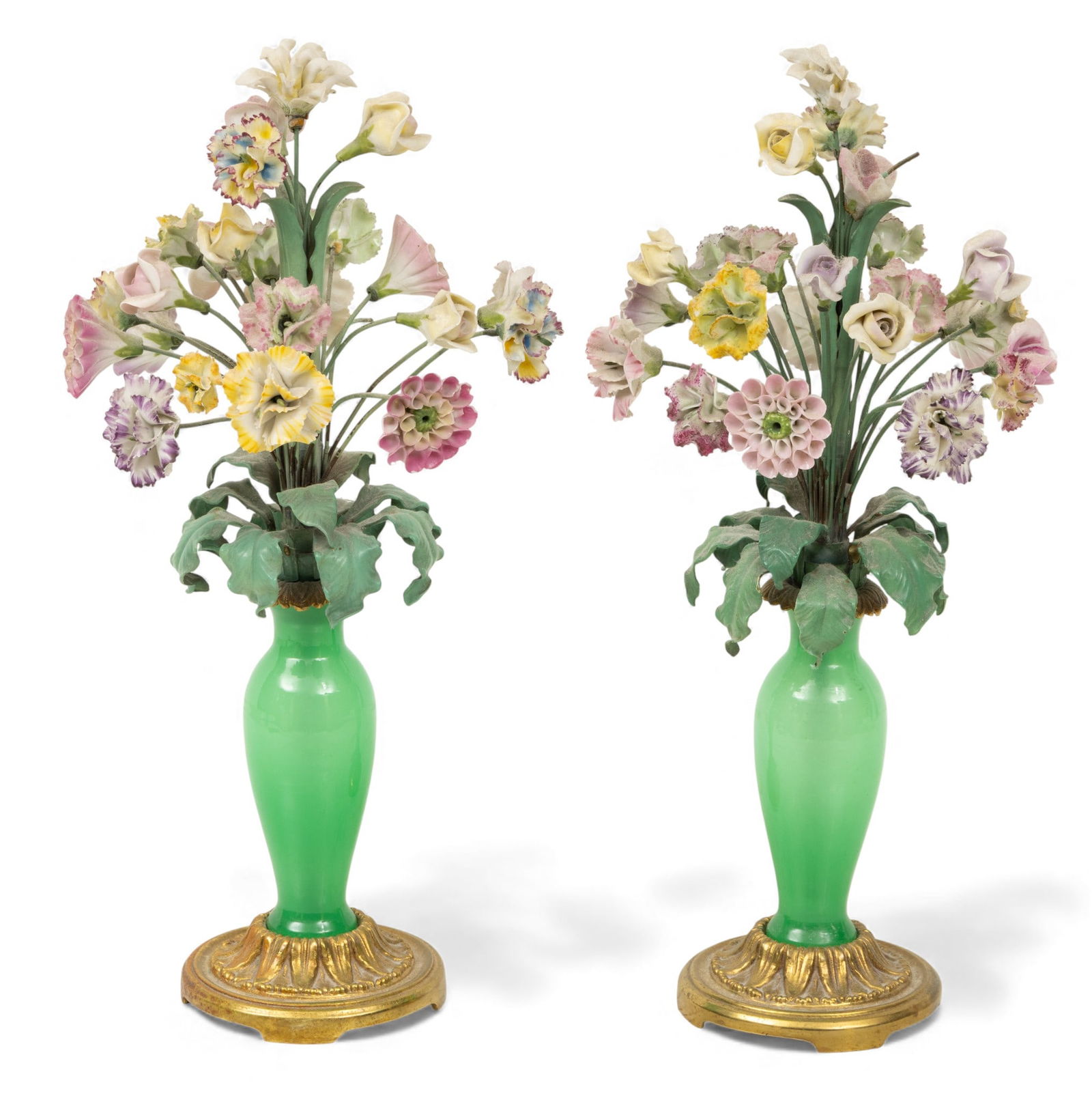 Italian Enameled Metal and Porcelain Flower Arraignments Set in Green Glass Vases, Ca. Mid 20th C.,: Italian Enameled Metal and Porcelain Flower Arraignments Set in Green Glass Vases, Ca. Mid 20th C., H 14.5" Dia. 7" 2 PCS Green glass vase bases with brass mountings. Enamel on metal stems and leaves