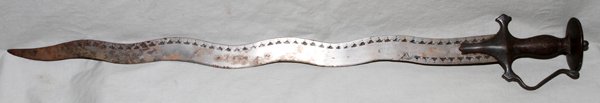 ANTIQUE INDO-PERSIAN TULWAR SWORD 19TH C, L 31": ANTIQUE INDO-PERSIAN TULWAR SWORD, 19TH C, L 31":Indo-Persian Tulwar sword with knuckle-guard, disk pommel and a wavy serpent style blade. Engraved geometric figures along the edges, etched hilt with 