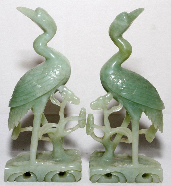 CHINESE CARVED JADE FIGURES OF CRANES, PAIR: CHINESE CARVED JADE FIGURES OF CRANES, PAIR, H 10":Each carved as a standing crane alongside foliage. From the Collection of John P. O'Hara, Bloomfield Hills, Mich.