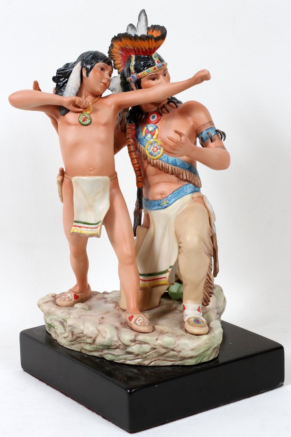 CYBIS PORCELAIN FIGURE GROUP H 8 1/2", L 7 1/2": CYBIS PORCELAIN FIGURE GROUP, H 8 1/2", L 7 1/2":depicts a Native American father kneeling next to his young son; Height with base 15". Signed Cybis, USA #2 on the integral base; all mounted on black