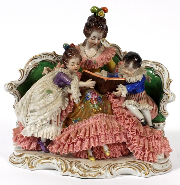 DRESDEN GERMAN PORCELAIN, MOTHER & CHILDREN: DRESDEN GERMAN PORCELAIN SEATED MOTHER & CHILDREN, H 8", W 8":Few Chips on the Lace. Mother with a Boy and Girl Seated upon a Settee.