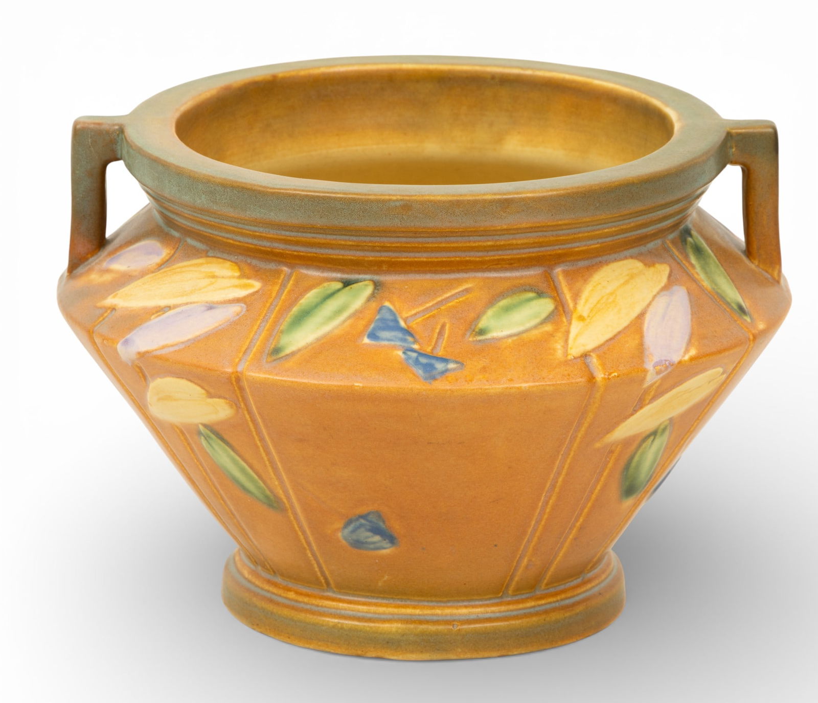 Roseville Pottery (American) Ceramic Futura Jardiniere, Ca. 1928, H 6.25" Dia. 8.5": Roseville Pottery (American) Ceramic Futura Jardiniere, Ca. 1928, H 6.25" Dia. 8.5" Two-handled ceramic planter with tan ground. Geometric lines and raised leaves in green, yellow, blue, and purple. N