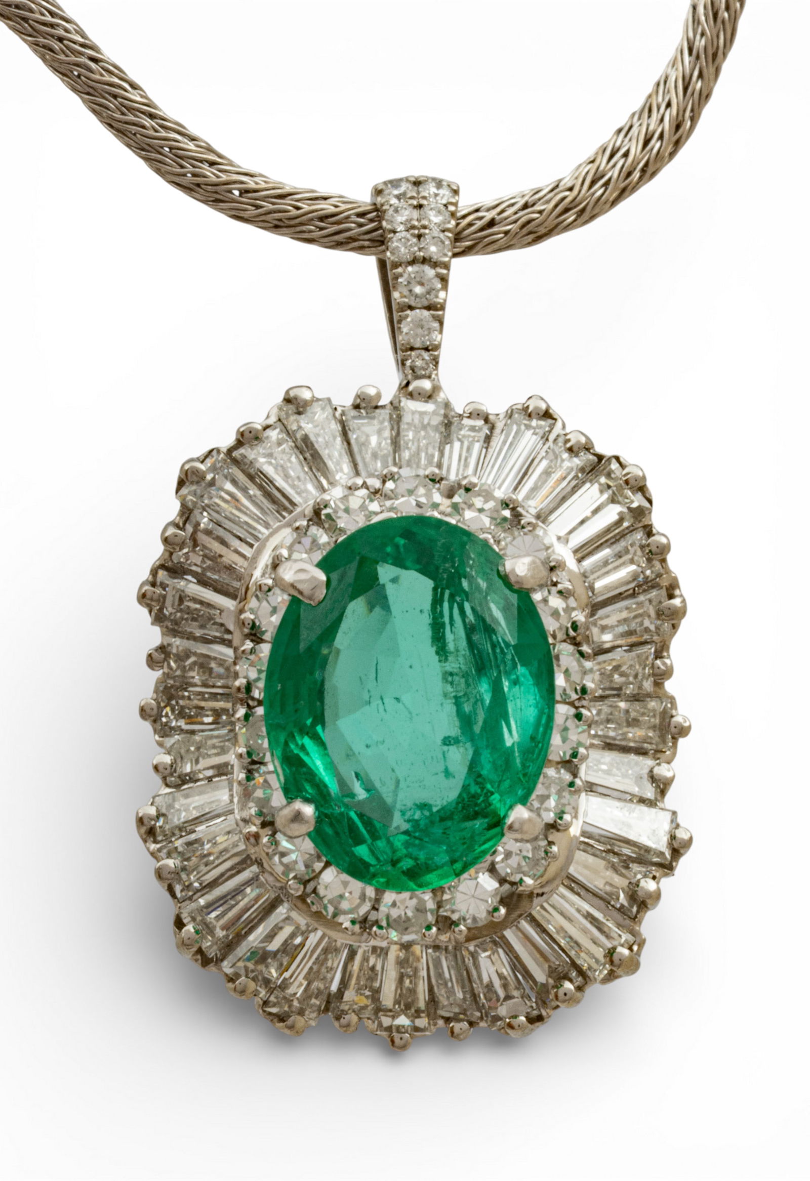 Ladies Platinum, Emerald, and Diamond Pendant Necklace H 1" L 15": Ladies Platinum, Emerald, and Diamond Pendant Necklace H 1" L 15" An oval-cut central emerald (11.75 x 9.20 x 4.090mm) in a double halo of 32 tapered baguette diamonds weighing appx. 1.84 carats total