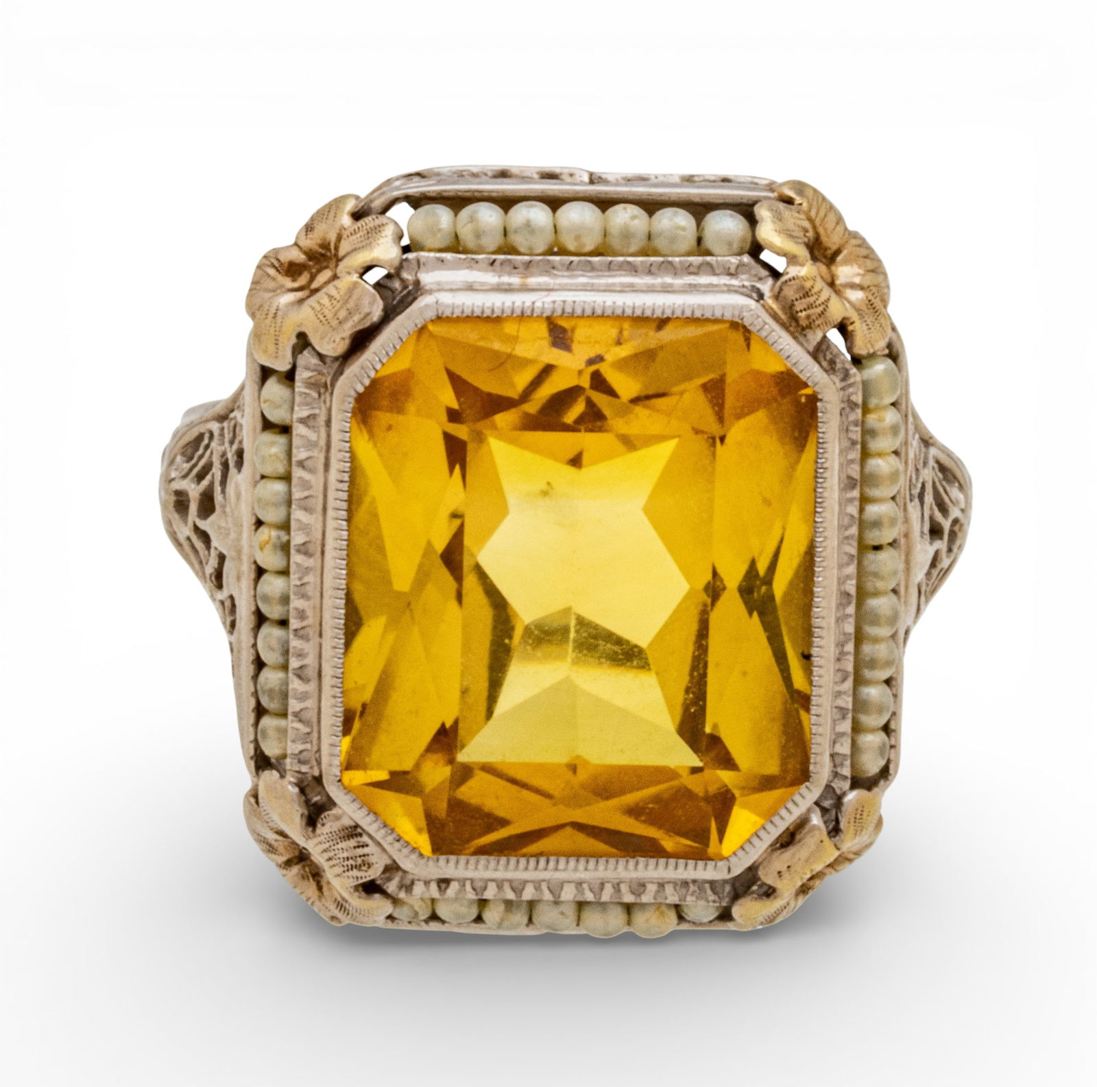 8 CT. Yellow Sapphire and 14 KT White Gold Ring Size 8: 8 CT. Yellow Sapphire and 14 KT White Gold Ring Size 8 Seed pearls surround sapphire. Circa 1940. Stamped 14k to the inside of the band. Provenance: Property from a Bloomfield Hills, MI private