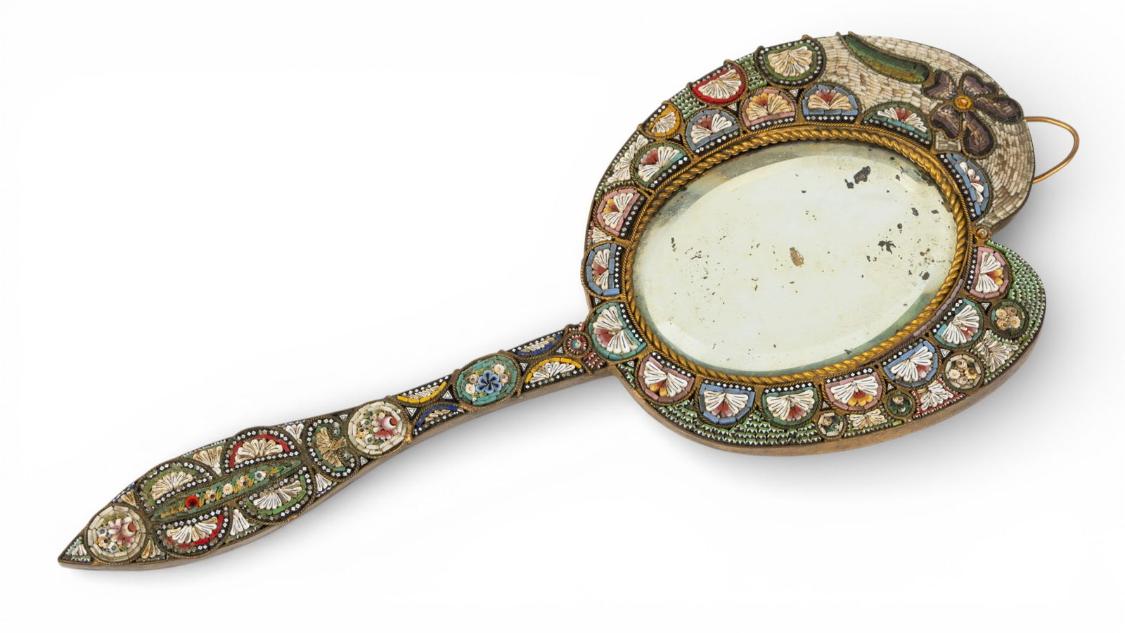 Italy, Micro Mosaic Stone Hand Mirror 1900, H 9" W 3.7" 1 PC: Italy, Micro Mosaic Stone Hand Mirror 1900, H 9" W 3.7" 1 PC Half circles surround the oval beveled mirror with fan interior motifs. Pattern is very intricate especially the handle with circles, dots