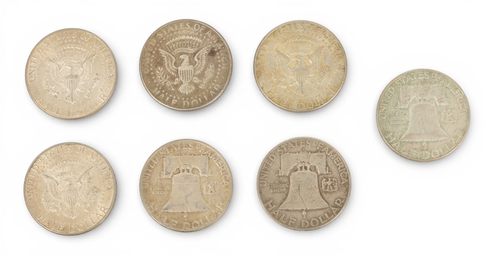 Kennedy Half Dollars (4) & Franklin Half Dollars (3) 7 PCS: Kennedy Half Dollars (4) & Franklin Half Dollars (3) 7 PCS Kennedy half dollars 4 - 1964. Franklin half dollars 3 1954, 1954, 1963. Dimensions: 7 PCS