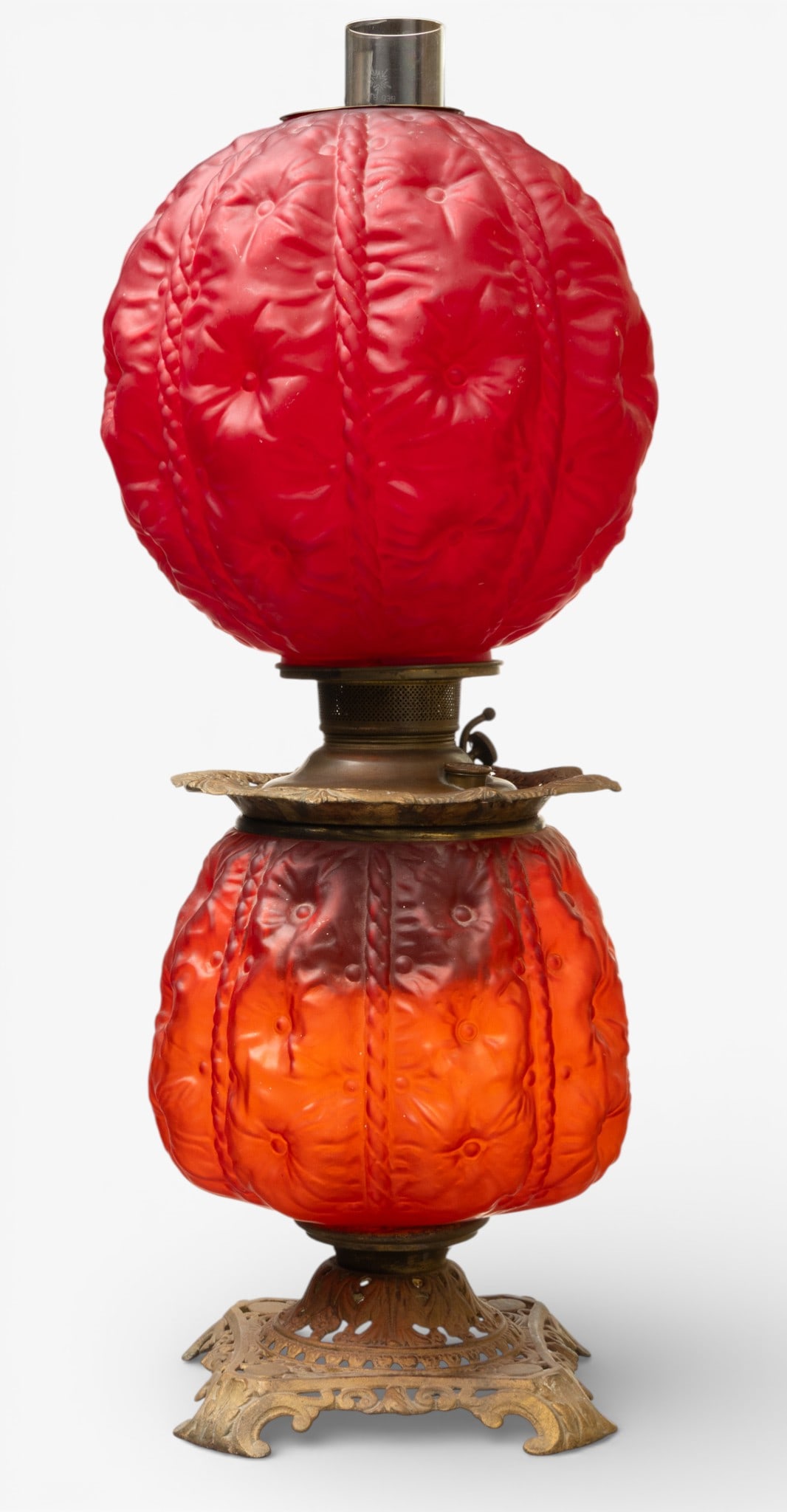 Edward Miller & Co. Victorian Two Globe 1895-1910, 'Juno 1 Gone with the Wind" Lamp', H 23" Dia. 11": Edward Miller & Co. Victorian Two Globe 1895-1910, 'Juno 1 Gone with the Wind" Lamp', H 23" Dia. 11" Having puffy floral ruby satin glass base and shade set in and on brass reticulated base and collar