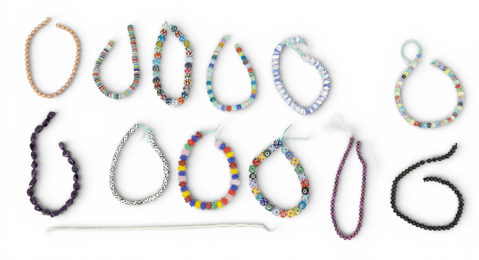 13 African Trade Bead Strands 13 PCS: 13 African Trade Bead Strands 13 PCS Thirteen strands of colorful African trade beads of various materials. Appx. volumetric dimensions for shipping 4 x 9 x 2 in. Provenance: Property from a Bl