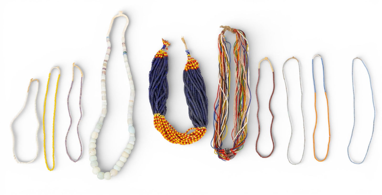 Ten African Trade Bead Necklaces 10 PCS: Ten African Trade Bead Necklaces 10 PCS Seven small bead necklaces of various colors (each appx. 24 in.), One multistrand small bead necklace (30 in.), one light blue/white bead necklace (38 in.), and
