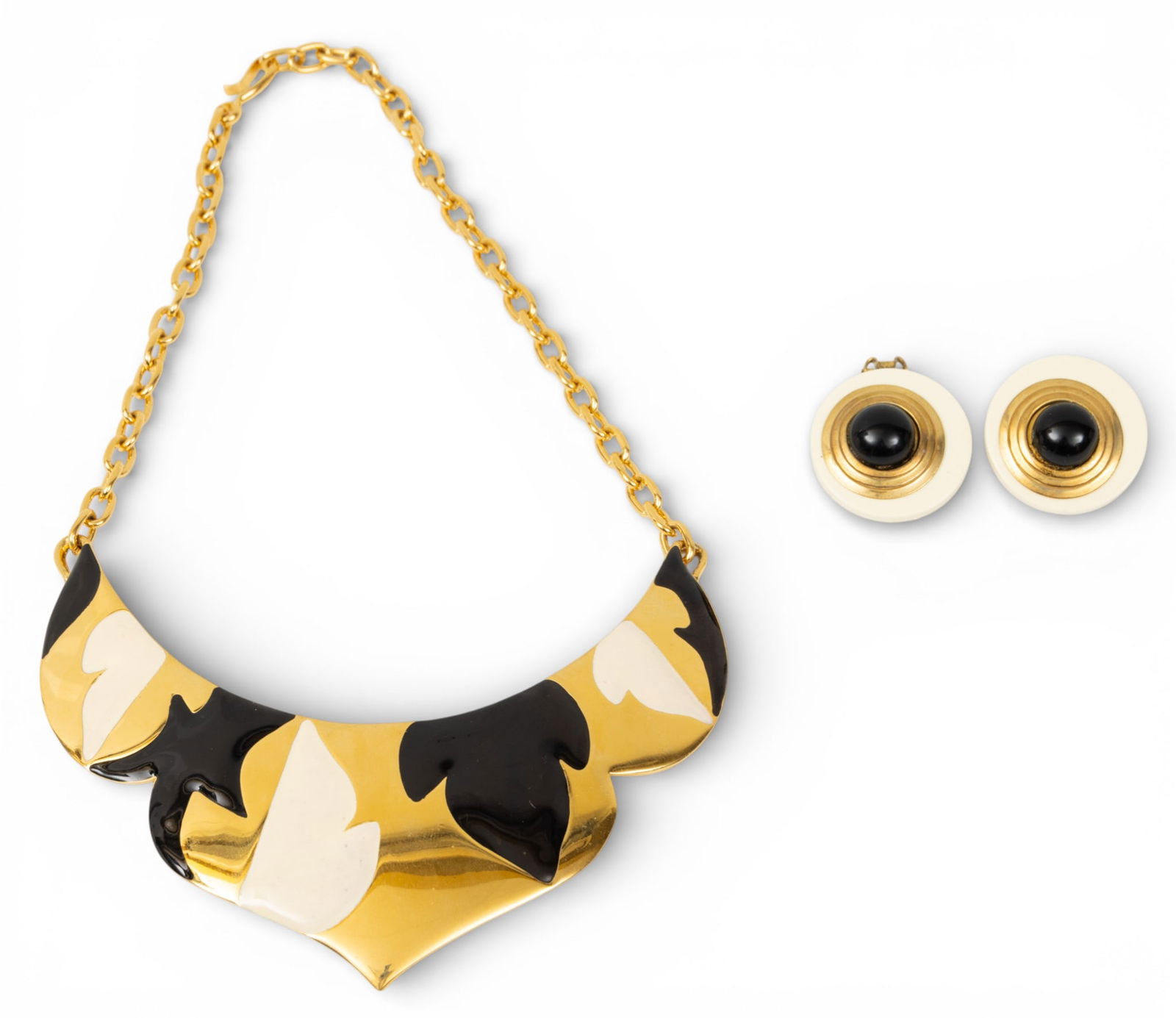 Monet Black and White Enameled Collar Necklace and Earrings, Ca. 1980, H 4.25" W 5" 1 PC: Monet Black and White Enameled Collar Necklace and Earrings, Ca. 1980, H 4.25" W 5" 1 PC Gold tone necklace with black enameled flowers. Unmarked disc clip-on earring with glass faux onyx center. 