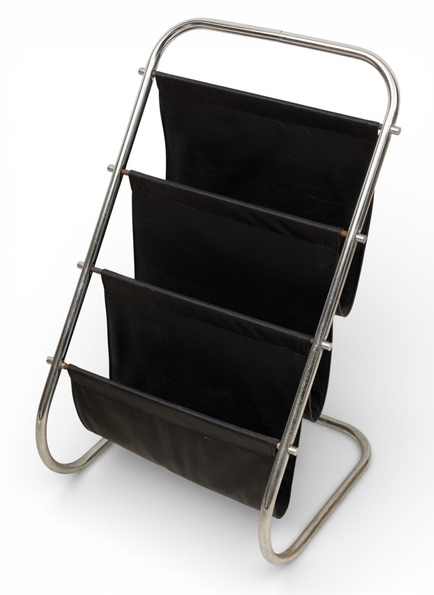Mid-Century Modern Chrome and Leatherette Magazine Stand, Ca. 1970, H 30" W 18" Depth 17.5": Mid-Century Modern Chrome and Leatherette Magazine Stand, Ca. 1970, H 30" W 18" Depth 17.5" In the manner of Marcel Breuer. Chromed steel tube construction with three black leatherette pouches. No app