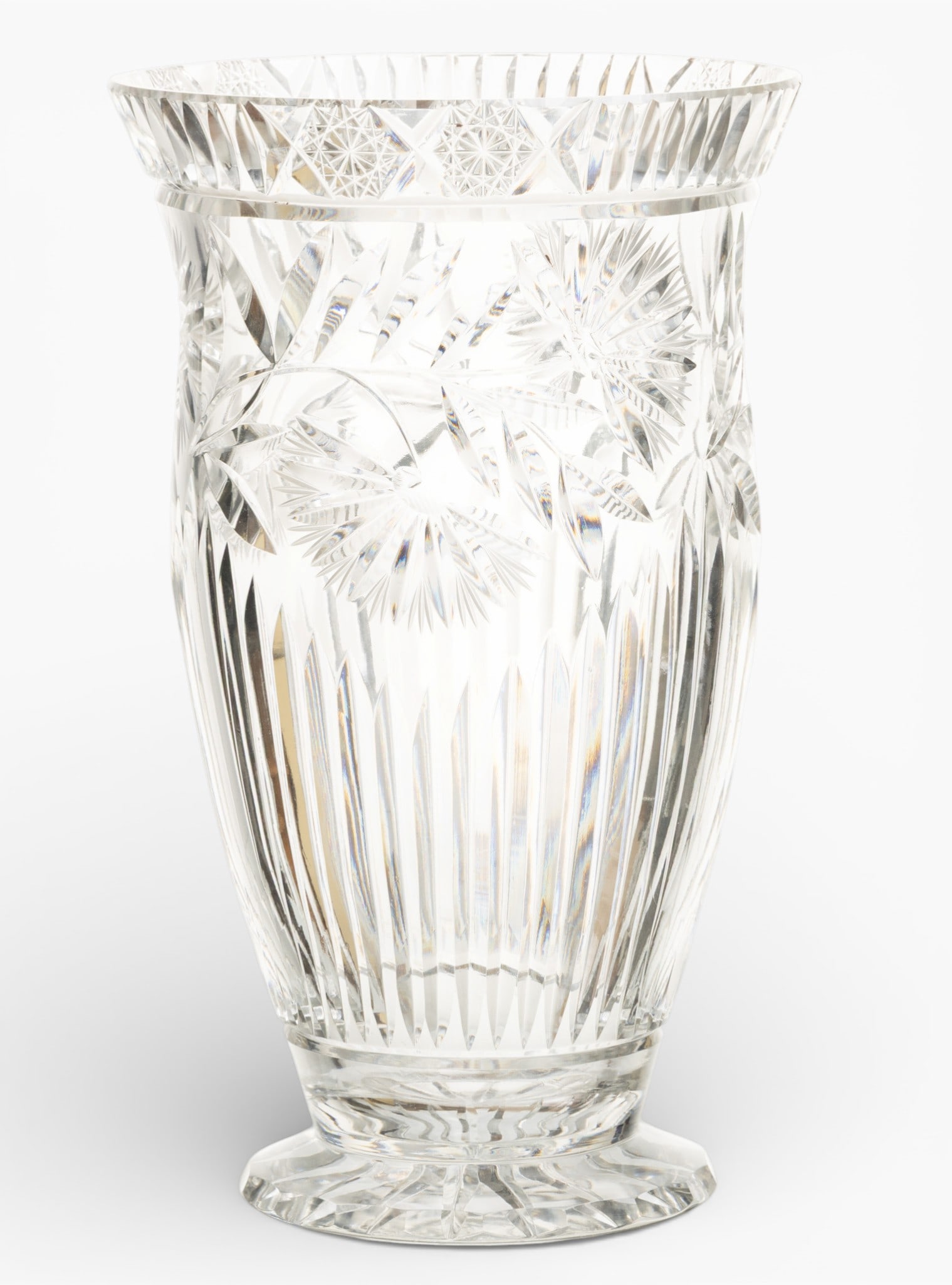 Cut Crystal Vase H 11" Dia. 6.5": Cut Crystal Vase H 11" Dia. 6.5" A large, cut crystal vase having flowers, starburst, and feather motif. Paneled and circular foot. No apparent marks. Provenance: Property from a Prominent Art