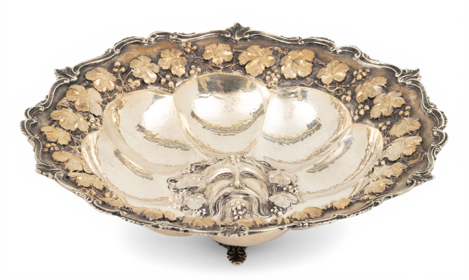 Greece, Sterling Silver Centerpiece, Mask of Wine God Bacchus H 2.7" Dia. 10" 12.8 t oz 1 PC: Greece, Sterling Silver Centerpiece, Mask of Wine God Bacchus H 2.7" Dia. 10" 12.8 t oz 1 PC Impressed 925. Raised on three feet. Hand made. Grape leaf and grape bunches surround head of Bacchus. Gold