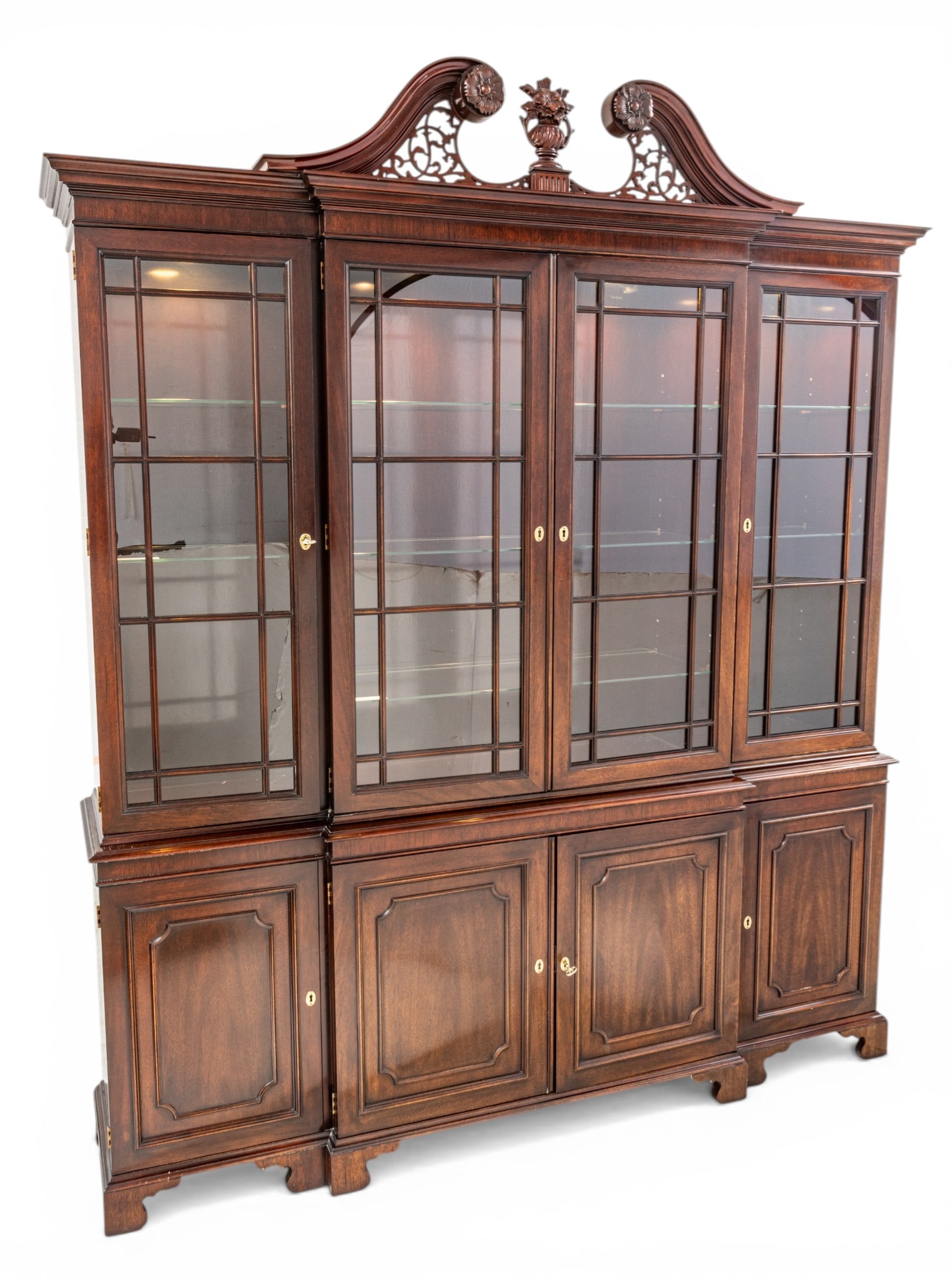 Kindel Furniture Company (American) George III Style Mahogany Breakfront 20th C., H 88" W 76" L 17": Kindel Furniture Company (American) George III Style Mahogany Breakfront 20th C., H 88" W 76" L 17" Mahogany, four-door glazed with mullions, interrupted filigree pediment with center finial. Three lo