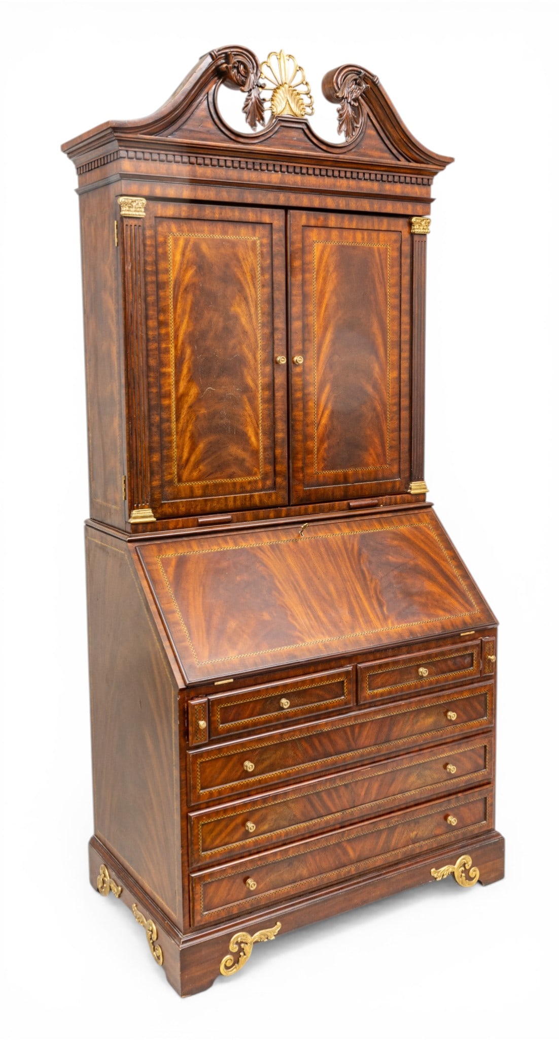 Maitland Smith Carved Mahogany Secretary Desk 20th Cent., H 92" W 40" Depth 25": Maitland Smith Carved Mahogany Secretary Desk 20th Cent., H 92" W 40" Depth 25" Having relief carved scrolling arch, centered by a brass filigree leaf crest. Upper wood paneled doors open to reveal an