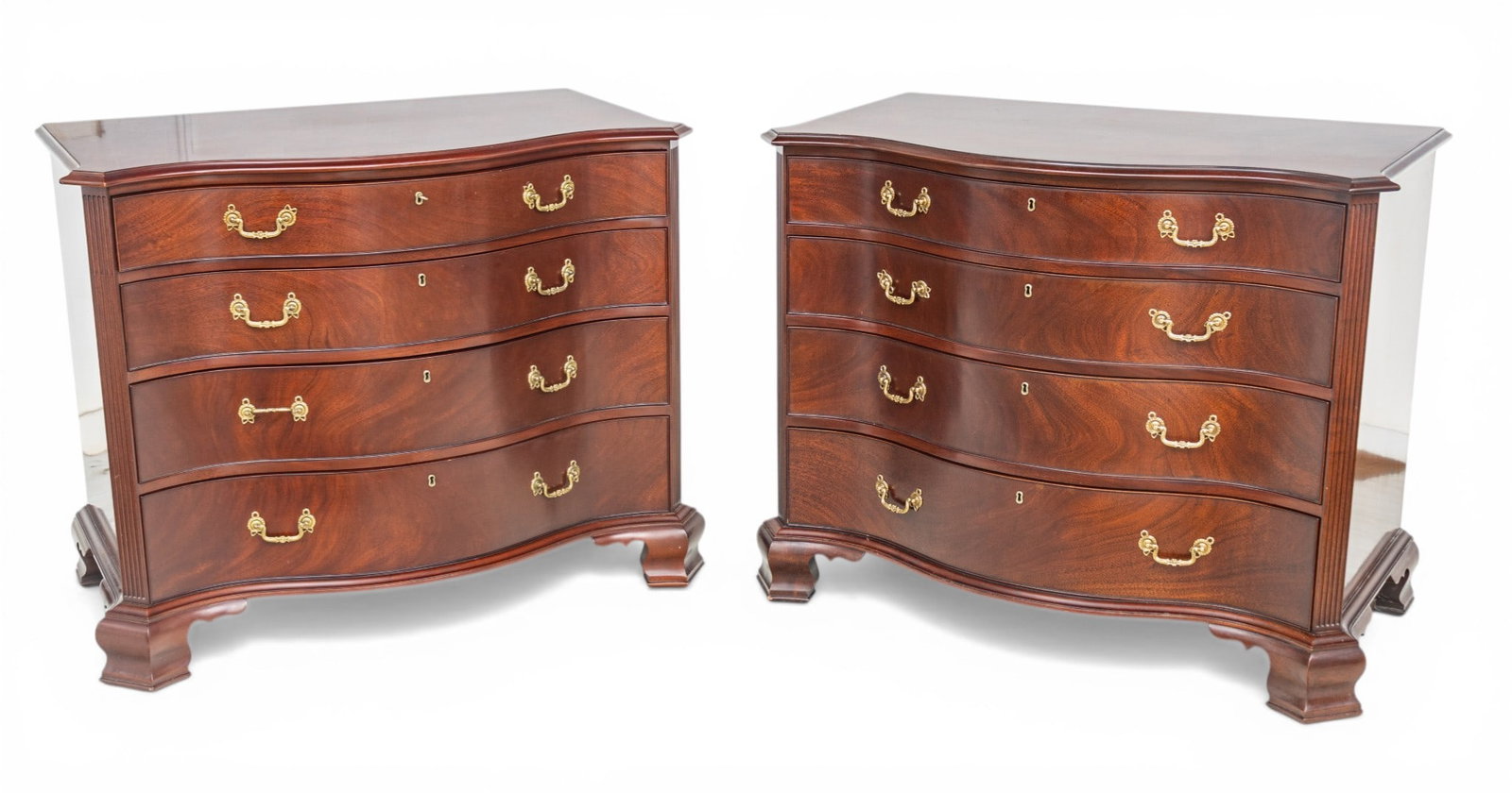 Kindel Furniture Company (American) Mahogany Masterworks Winterthur Reproduction Chests 20th C., H: Kindel Furniture Company (American) Mahogany Masterworks Winterthur Reproduction Chests 20th C., H 36" W 42" Depth 27" 1 PAIR Mahogany, serpentine chests having four drawers with brass handles flanked