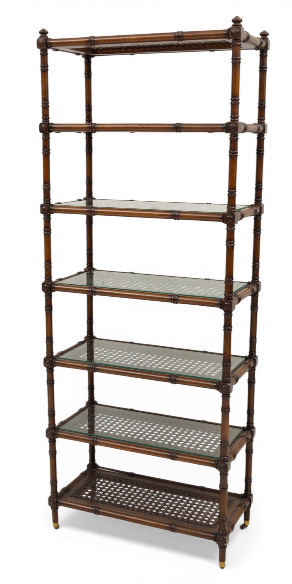 Carved Mahogany Seven Tier Book Shelf H 75" L 29" Depth 14.5": Carved Mahogany Seven Tier Book Shelf H 75" L 29" Depth 14.5" Central column base with four splayed legs on brass castors. Each shelf is inset with cane and four have glass shelves over the cane. 