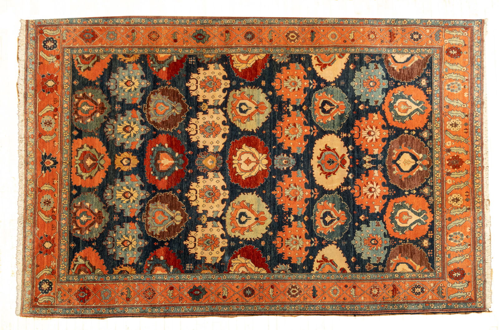 Woven Legends (Philadelphia/Turkey) Fine Rubia Handwoven Wool Rug, Ca. 2000, W 7' 8" L 11': Woven Legends (Philadelphia/Turkey) Fine Rubia Handwoven Wool Rug, Ca. 2000, W 7' 8" L 11' Navy field with repetitious floral blossoms. Salmon outer border. Provenance: Property from the collec