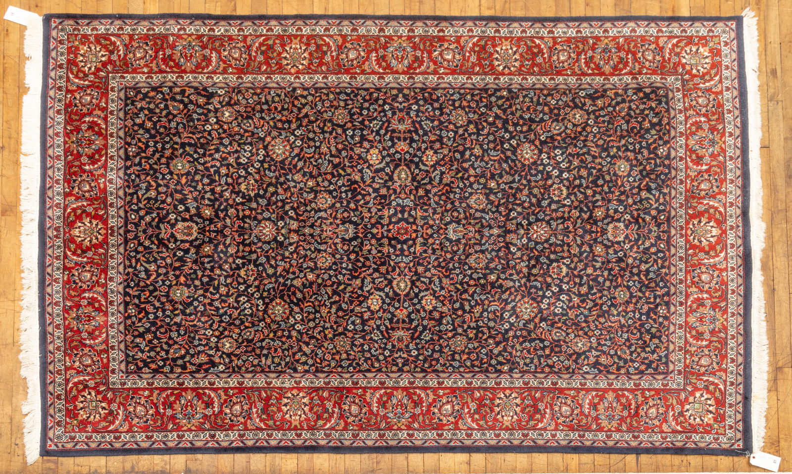 Persian Hereke Handwoven Wool Rug, 1970, W 6' L 8' 9": Persian Hereke Handwoven Wool Rug, 1970, W 6' L 8' 9" Navy field with dense scrolling vine and floral patterns. Rust outer border also with vine and floral designs. Provenance: Property from th