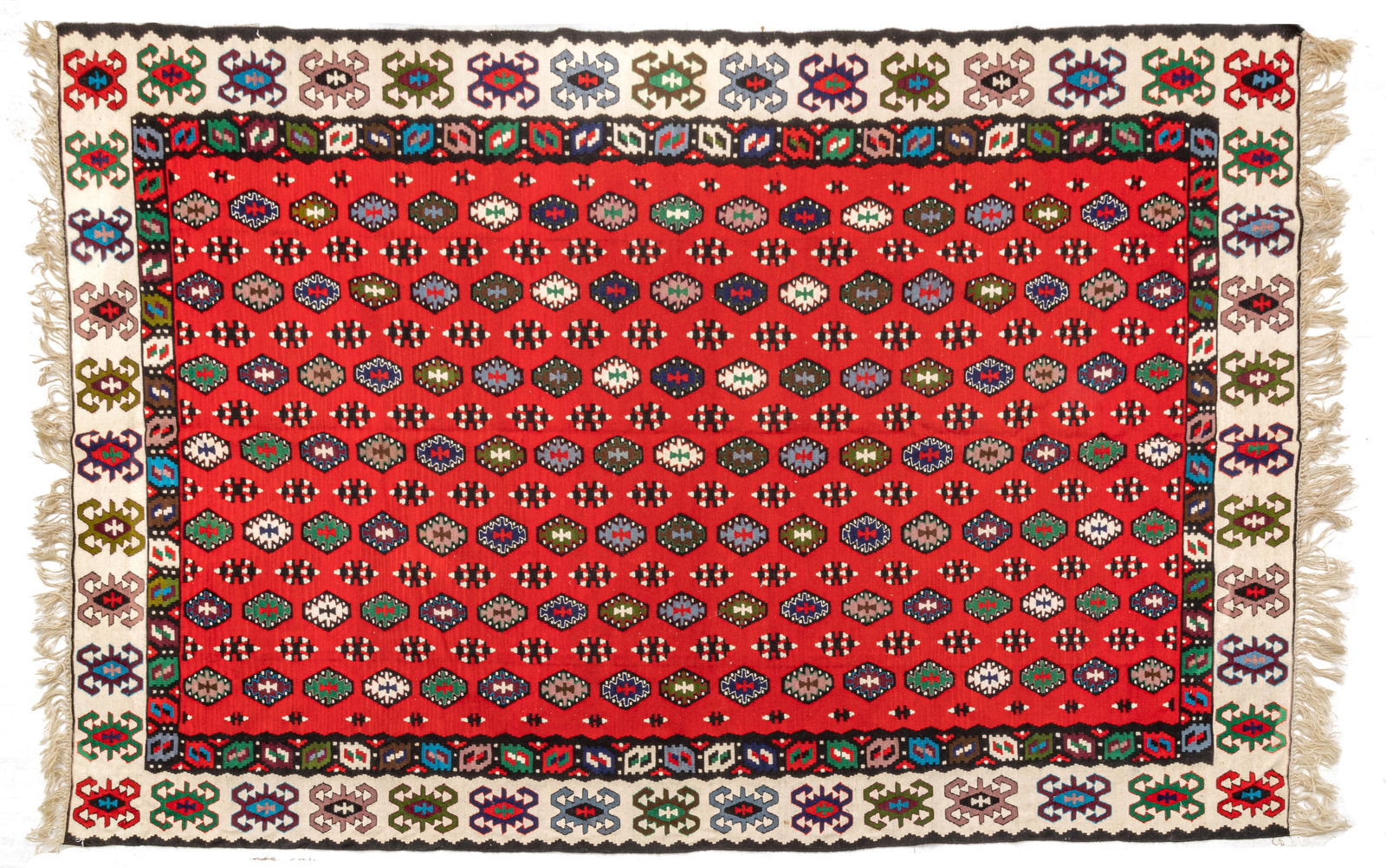 Turkish Kilim Handwoven Wool Rug, Ca. 1990, W 6' 6" L 9' 8": Turkish Kilim Handwoven Wool Rug, Ca. 1990, W 6' 6" L 9' 8" Flat woven Kilim with a deep red central field. With repetitious geometric medallions. Provenance: Property from the collection of Ma