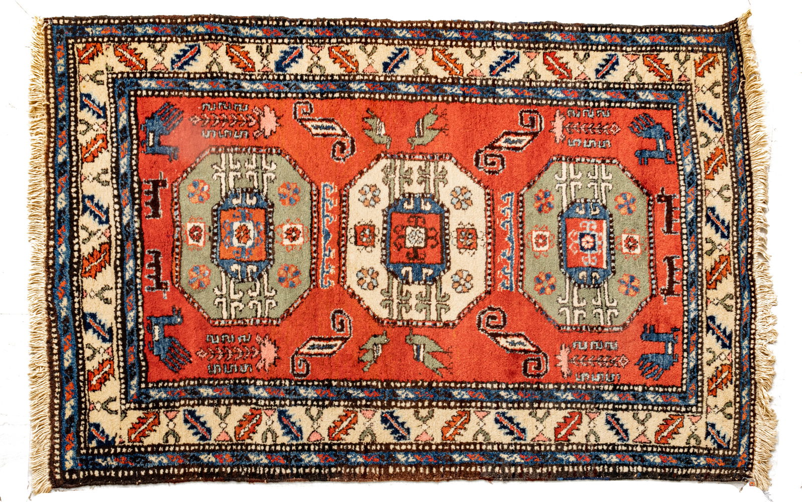 Persian Ardibil Kazak Design Handwoven Wool Rug, Ca. 1970, W 3' 8" L 5' 5": Persian Ardibil Kazak Design Handwoven Wool Rug, Ca. 1970, W 3' 8" L 5' 5" Having a red central field with three geometric medallion. Stylized bird accents with beige and navy outer borders. Pro