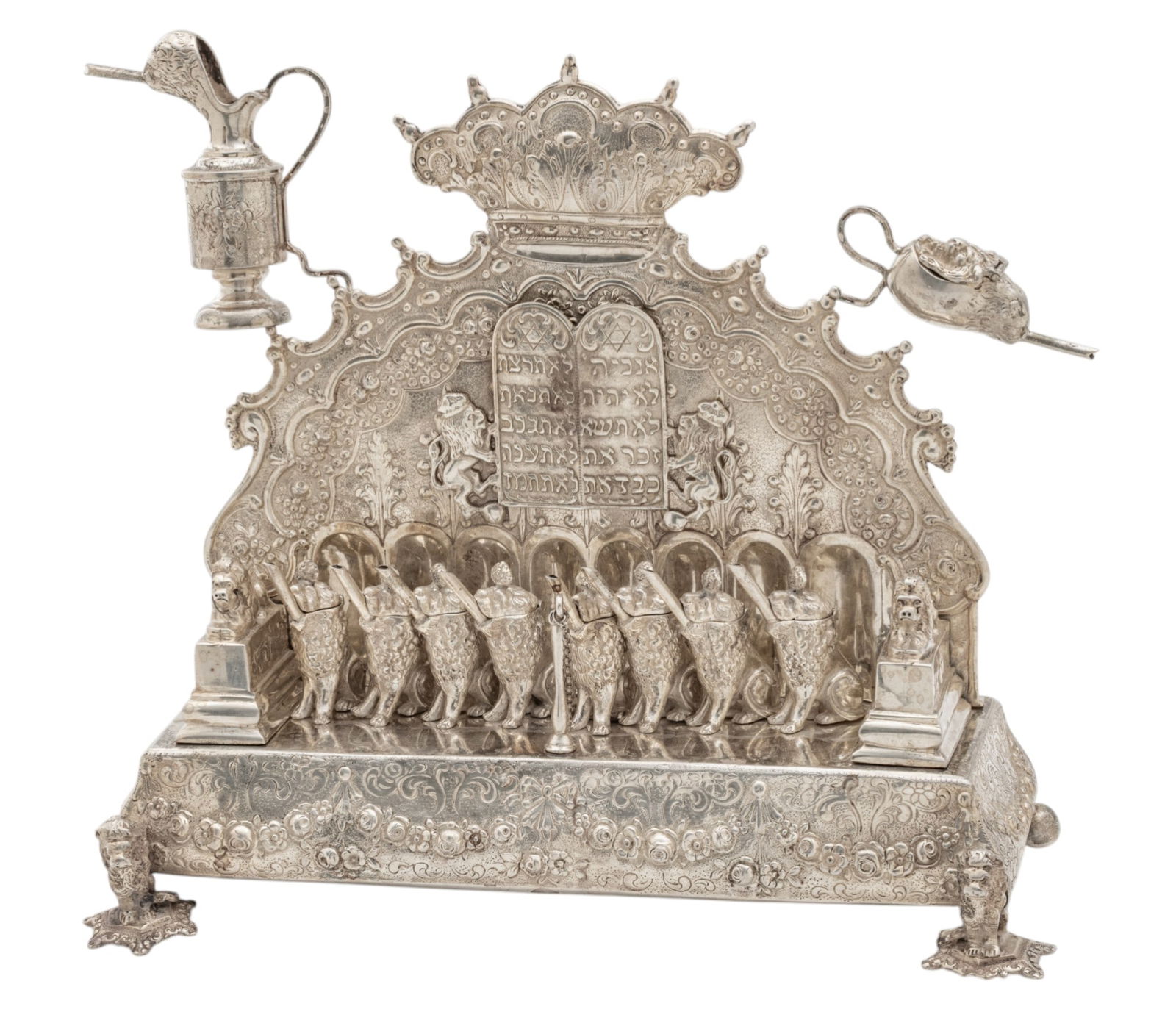 Silver Elaborate Menorah Lamp 19th.c., H 11" W 12" Depth 5" 54 t oz 1 PC: Silver Elaborate Menorah Lamp 19th.c., H 11" W 12" Depth 5" 54 t oz 1 PC Hand made with much detail. Oil lamps are individually made and bolted to stand. Traditional Jewish Hanukkah menorah designed t