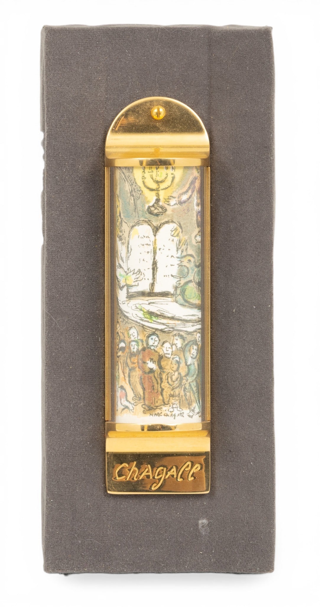 Marc Chagall (French/Russian, 1887-1985) Judaica Lithograph on 24K Gold Plate Mezuzah, in Fitted Box: Marc Chagall (French/Russian, 1887-1985) Judaica Lithograph on 24K Gold Plate Mezuzah, in Fitted Box H 5.2" W 1.5" 1 PC Created by Menahem Berman of ARTA Gallery, Jerusalem. #2462/5748. Eighteen