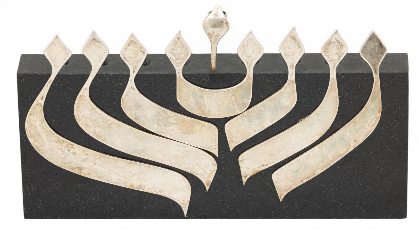 Judaica Menorah, Silver on Black Marble Modern, H 5.5" L 9.5" Depth 1" 1 PC: Judaica Menorah, Silver on Black Marble Modern, H 5.5" L 9.5" Depth 1" 1 PC Candleholders on marble. Applied silver flame forms to front panel. No silver marks. Modern. Provenance: Property of a Troy