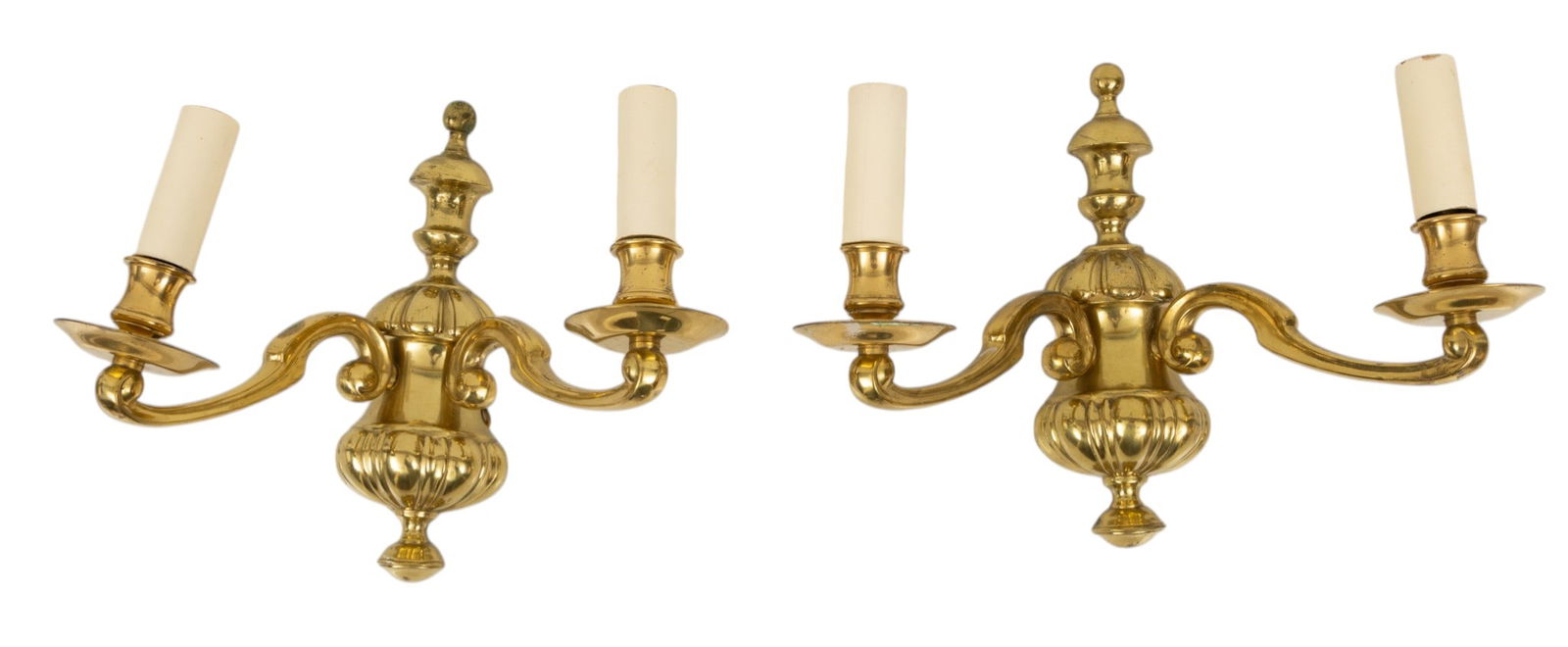 American Colonial Revival Style Brass Two Light Wall Sconces, Ca. 20th C., H 10.25" W 12.25" Depth: American Colonial Revival Style Brass Two Light Wall Sconces, Ca. 20th C., H 10.25" W 12.25" Depth 7.5" 2 PCS Baluster form wall mount with two scrolling arms. Candlestick style candelabra lights. Ele