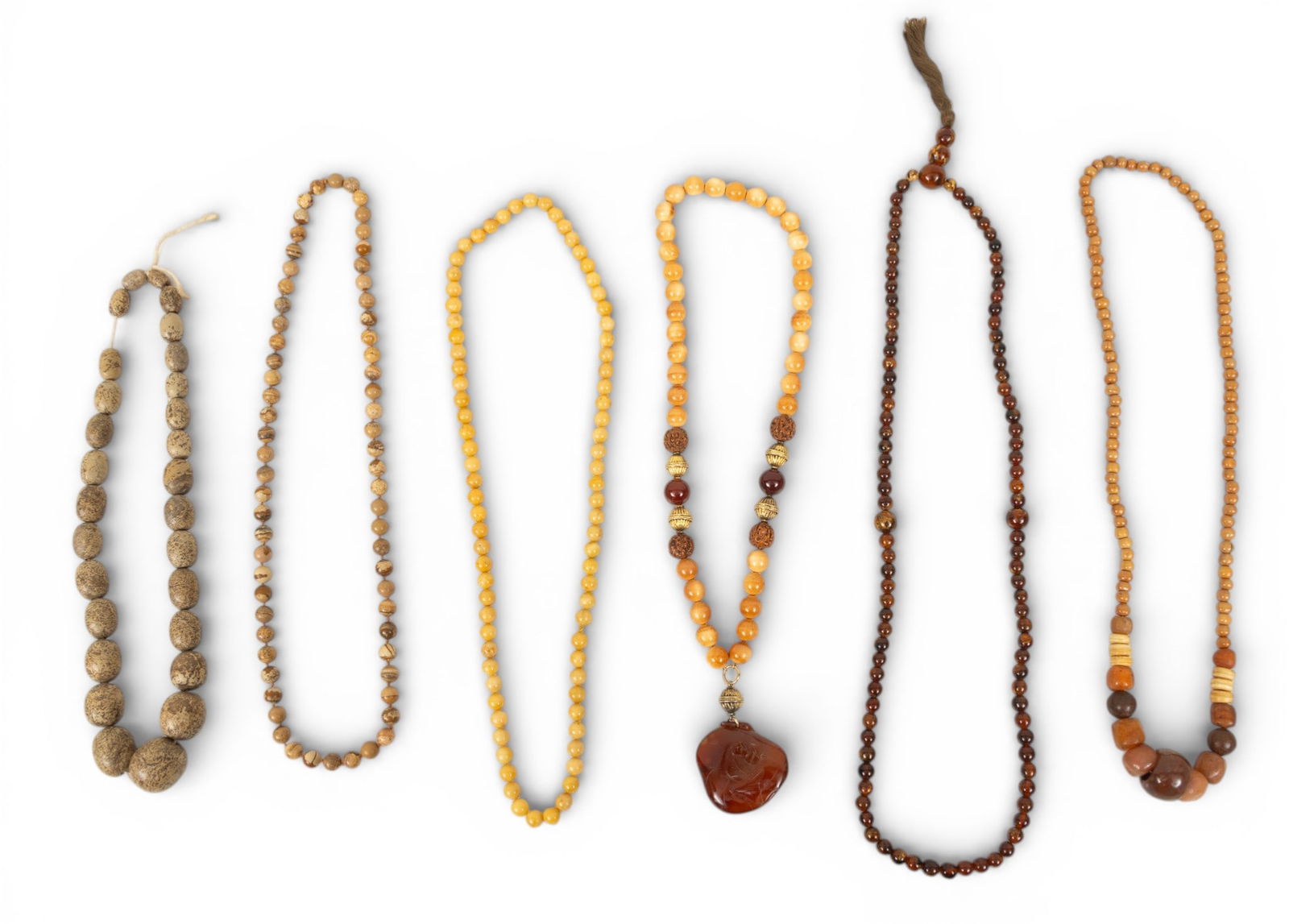 Six African Hardstone and Amber Trade Bead Necklaces 6 PCS: Six African Hardstone and Amber Trade Bead Necklaces 6 PCS Six hardstone African trade bead necklaces, one having carved Amber leaf pendant. Provenance: Property from a Midland, MI private coll
