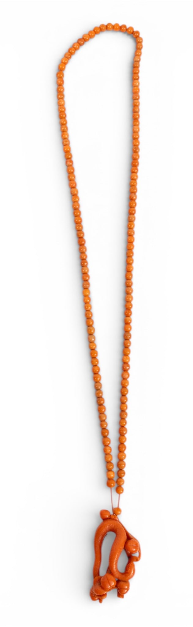 Coral Bead and Carved Coral Snake Pendant Necklace H 2.75" L 38": Coral Bead and Carved Coral Snake Pendant Necklace H 2.75" L 38" A beautifully detailed carved coral snake among fruiting peach branches as a pendant on a coral bead necklace. In a round, silk storage