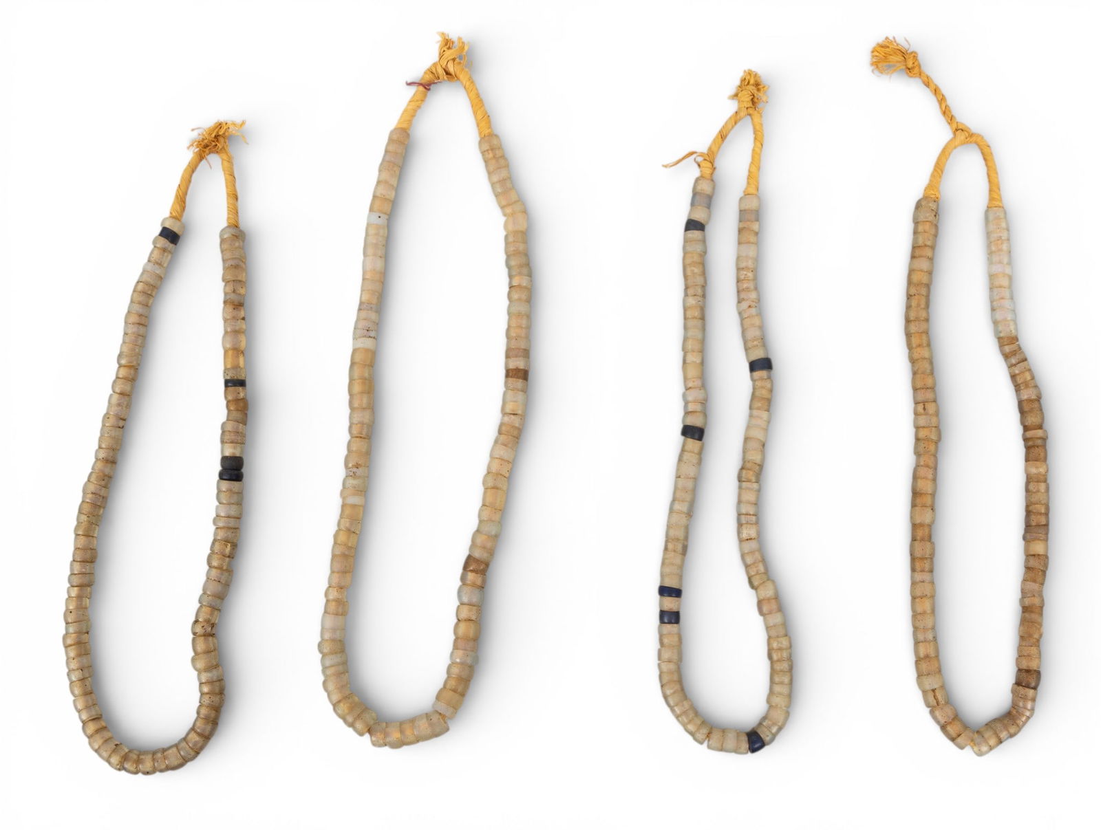 Mali White Dogon Glass Bead Necklaces L 24" 4 PCS: Mali White Dogon Glass Bead Necklaces L 24" 4 PCS Four Nigerian white Dogon glass trade bead necklaces strung on natural fibers. Provenance: Property from a Midland, MI private collector Dimens