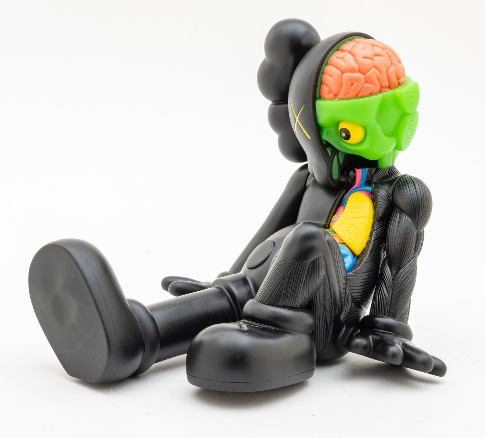 KAWS (Brian Donnelly) (American, B. 1974) Painted Cast Vinyl Resting Place Companion (Black), 2013,: KAWS (Brian Donnelly) (American, B. 1974) Painted Cast Vinyl Resting Place Companion (Black), 2013, H 8" W 8" L 10" Cast vinyl Resting Place Companion in black. Bisected figure with painted organs. Wi