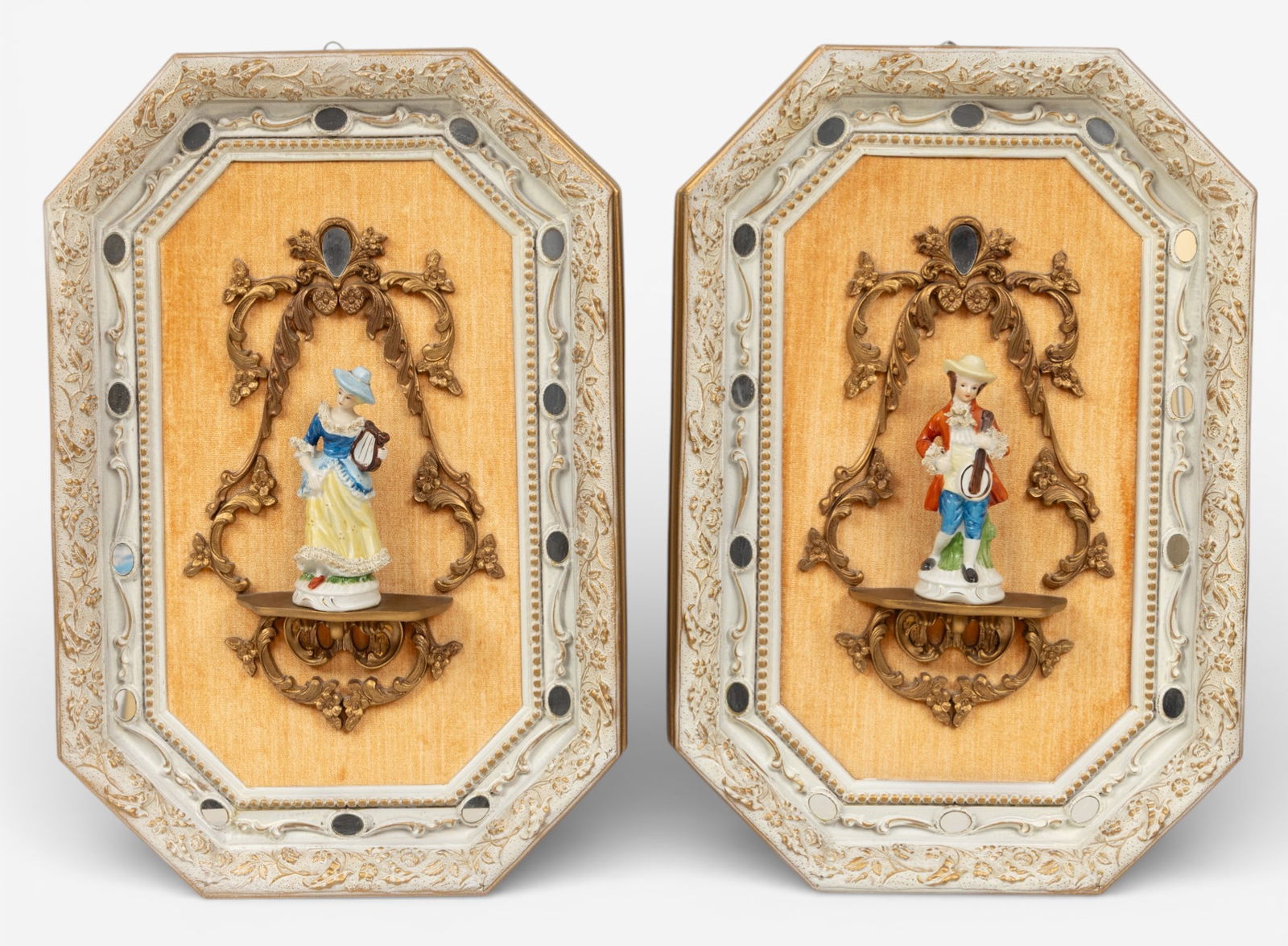 Wall Pieces with Porcelain Figures on Curio Shelves 1950 1960, H 27" W 18" 1 PAIR: Wall Pieces with Porcelain Figures on Curio Shelves 1950 1960, H 27" W 18" 1 PAIR Size is overall including frame. Porcelain figures: girl with harp, boy with banjo. Octagonal frames are decorated wit